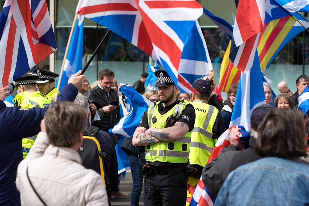 Police monitor protests at a Scottish Independence (AUOB) march.