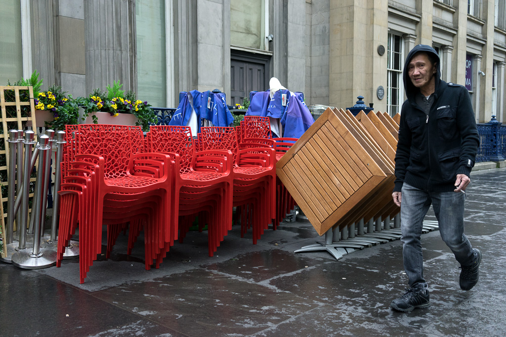 Man smoking a cigarette walks past the Gallery Of Modern Art in Glasgow