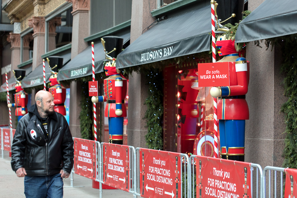 Man walks past Christmas windows at The Hudson's Bay, Queen Street West, Toronto