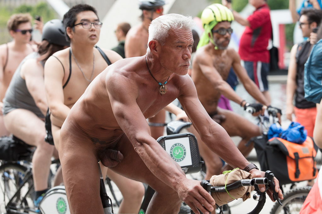 Naked man on a bicycle.