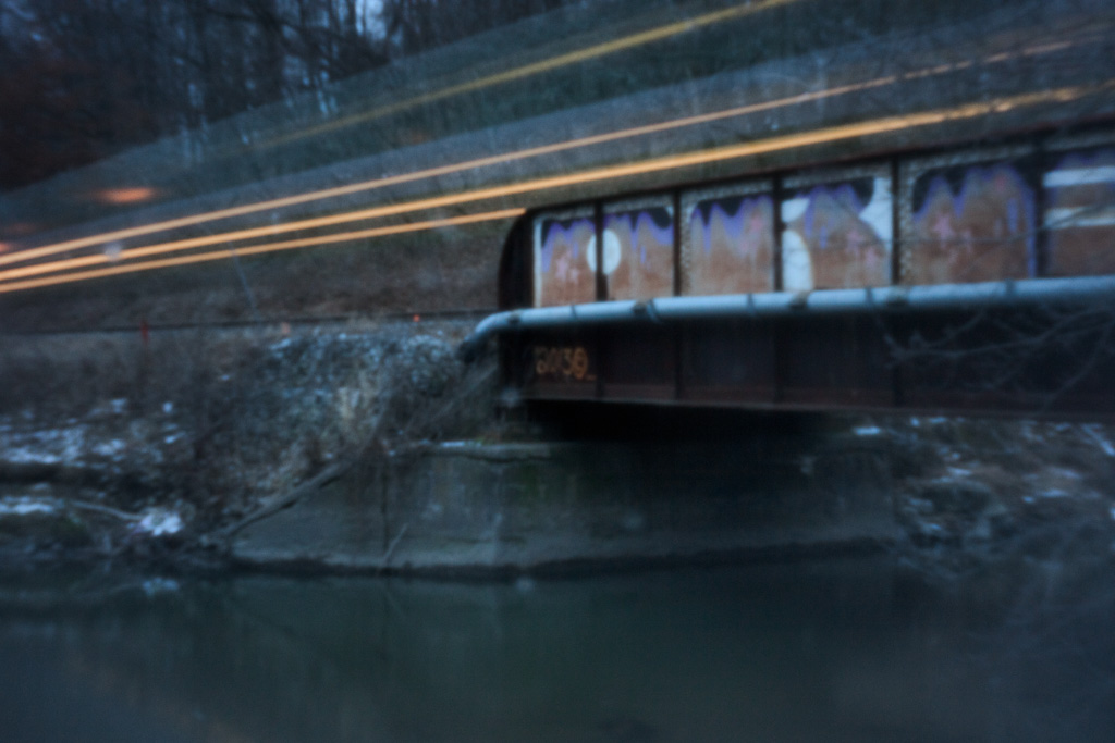 Long pinhole exposure of a Go Train whizzing over the Don River on its evening run.