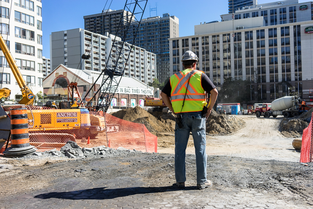 Construction worker surveys site of future condominium at the corner of Alexander & Yonge Street, Toronto