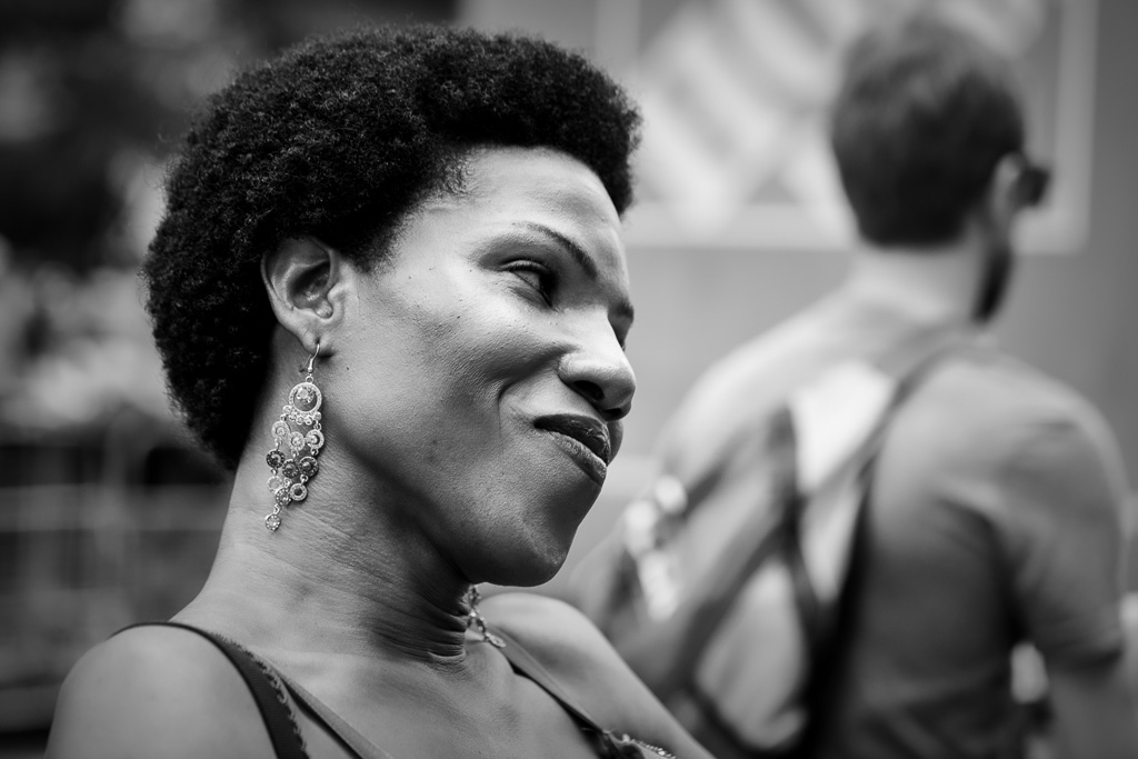 Candid street portrait of a Black person wearing decorative earrings.