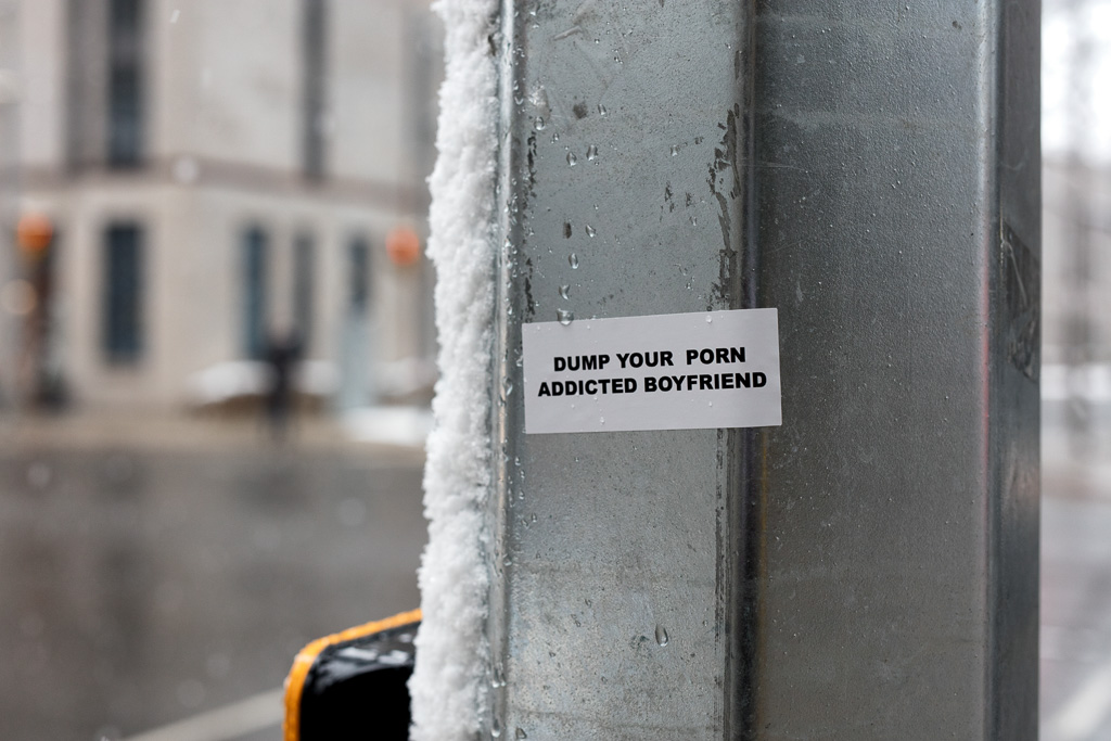 Sticker on a utility pole on Toronto's Bay Street which reads: Dump Your Porn Addicted Boyfriend.