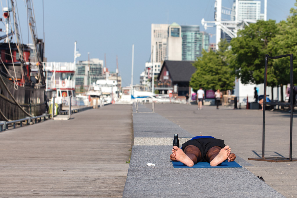Lying on bench doing nothing on Queen's Quay in Toronto