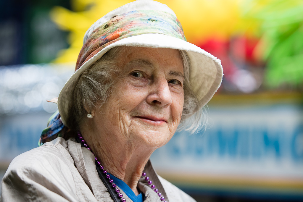Street portrait of an elderly woman wearing a hat and watching the Pride Parade marshall at the corner of Park and Rosedale Valley Road in Toronto